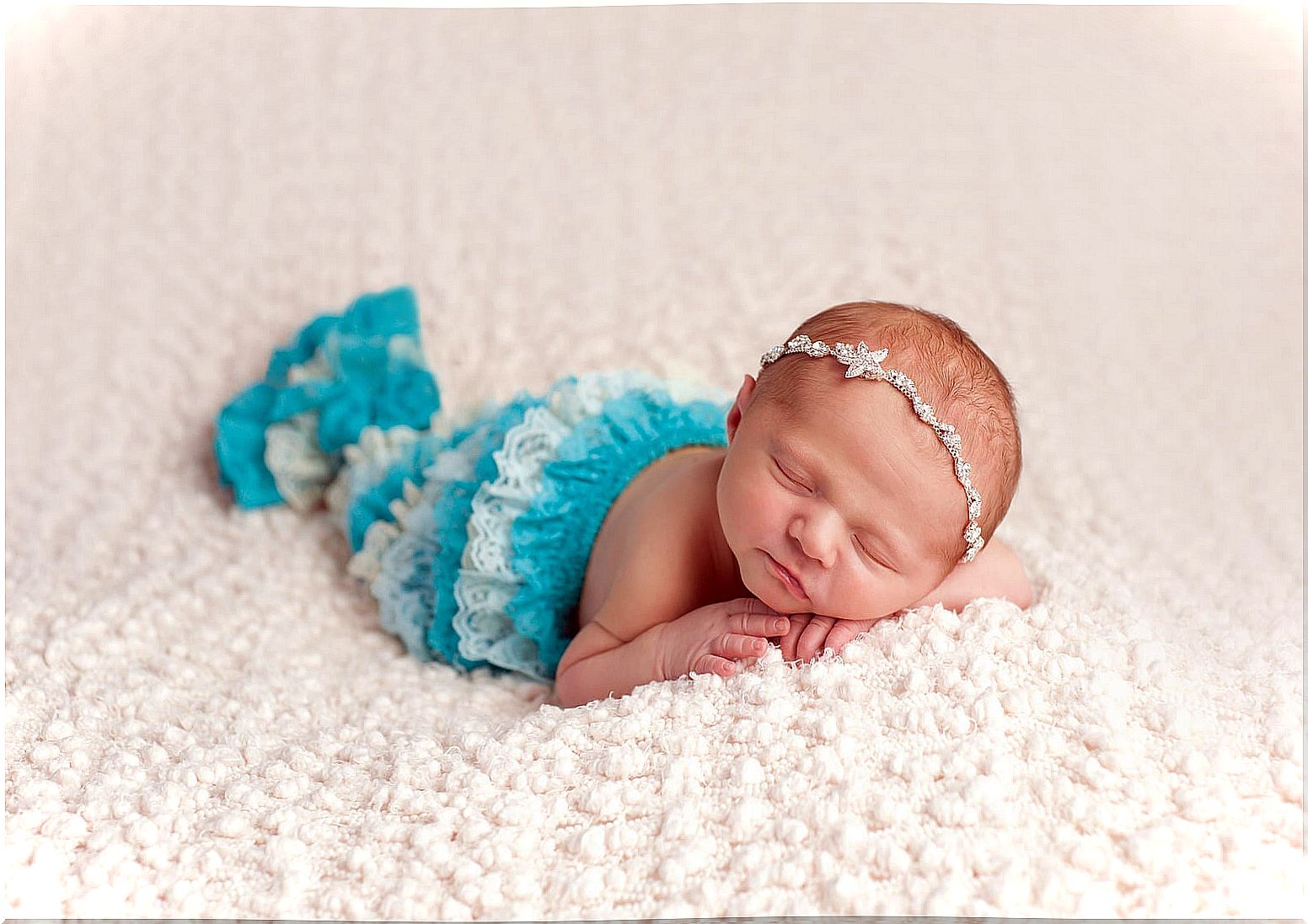 Baby with a name inspired by the sea dressed as a mermaid.