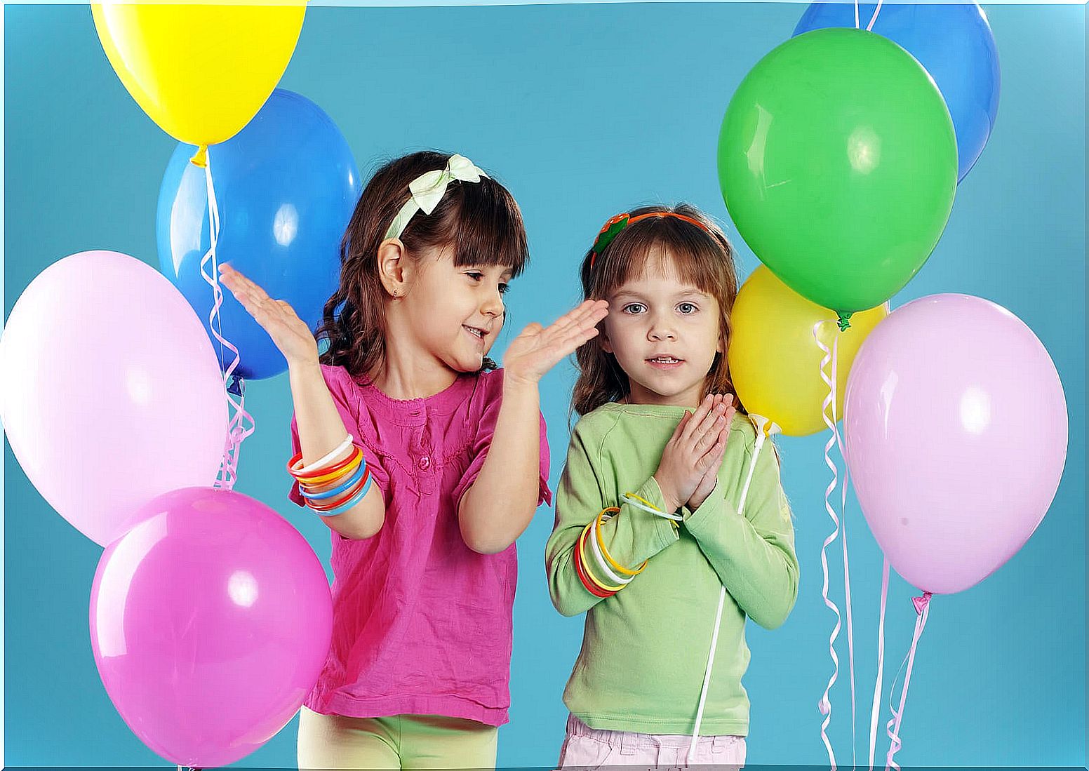 Girls with balloons at their birthday party.