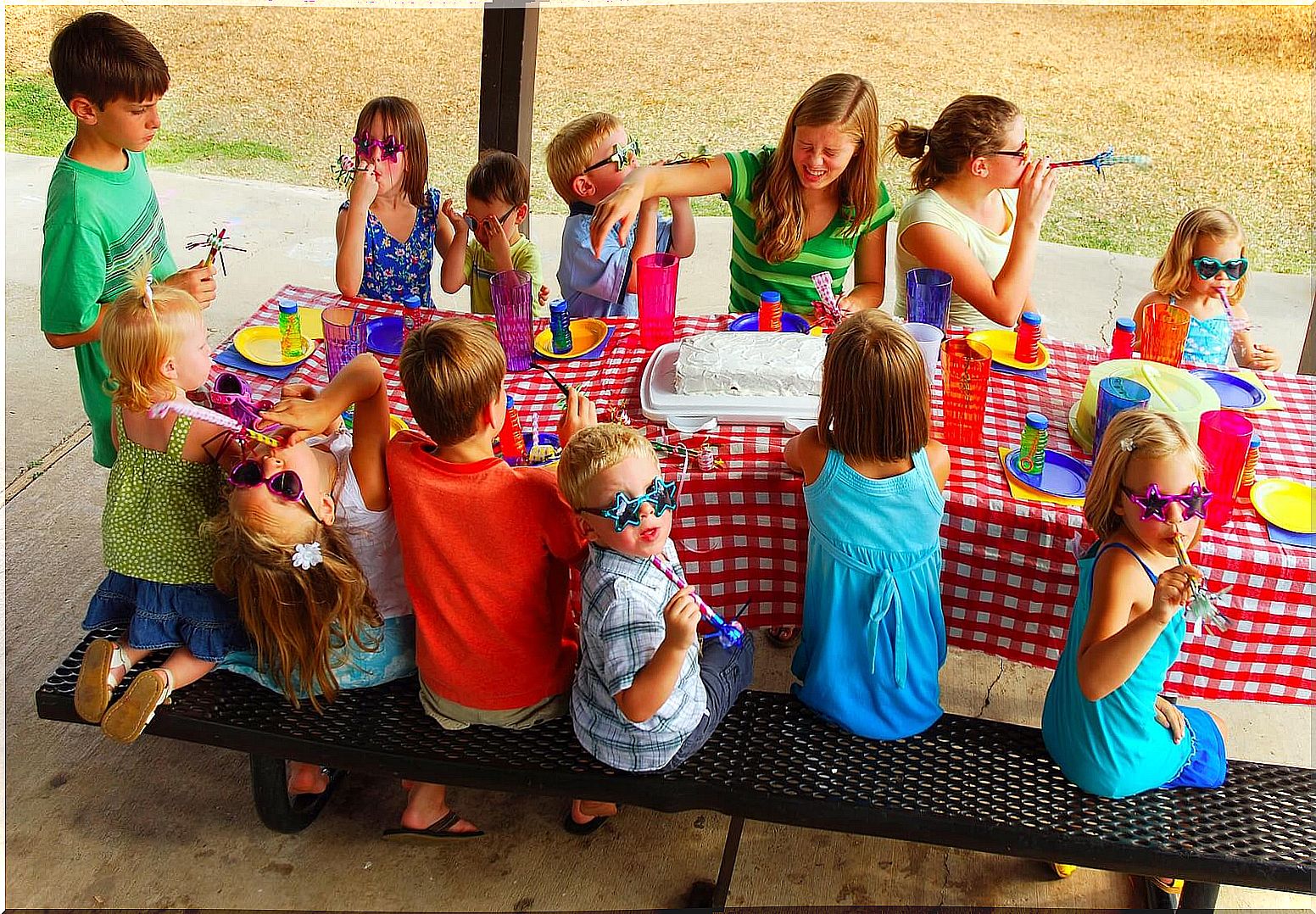 Children celebrating a birthday party with their classmates.