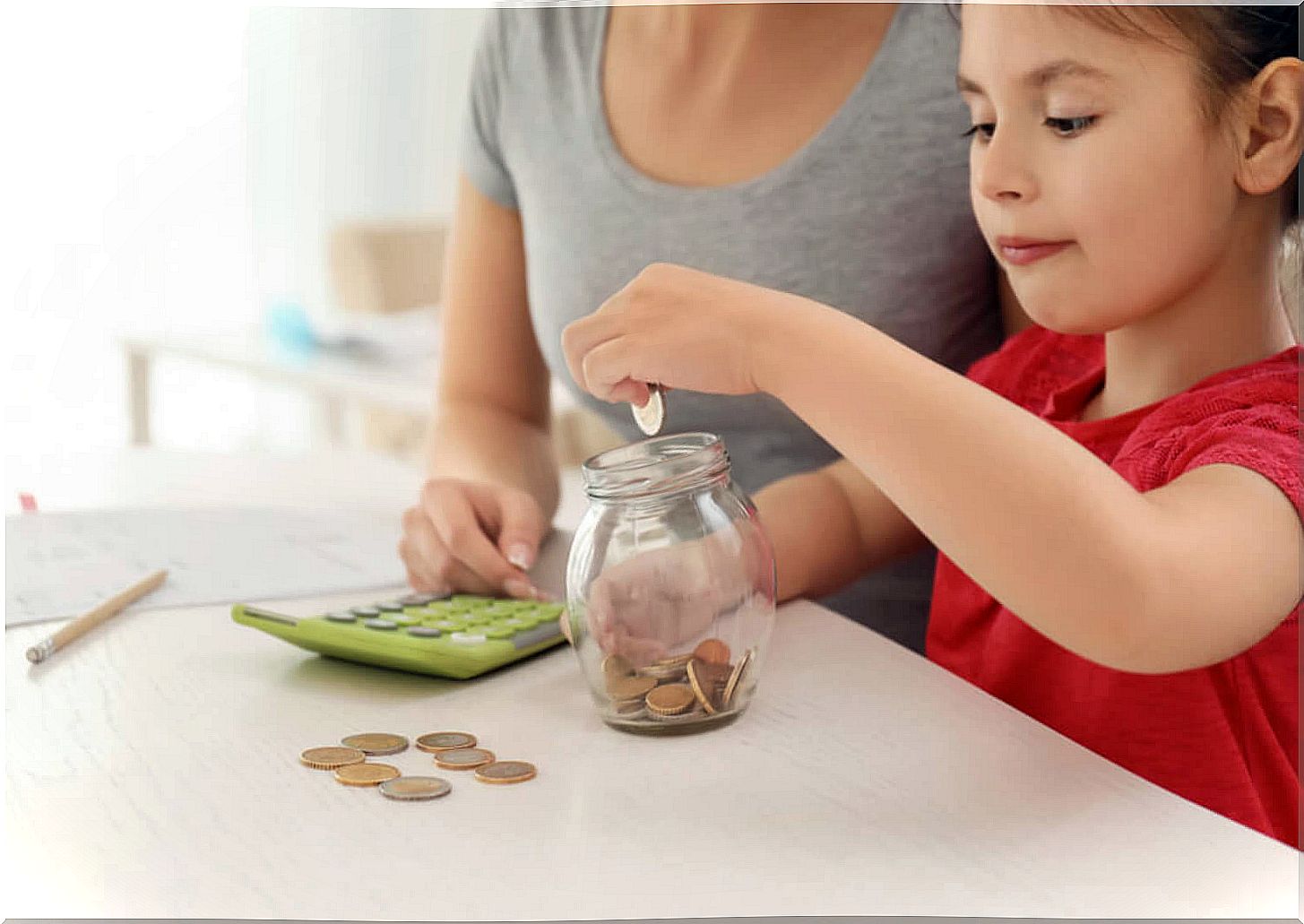 Mother applying the tips to teach her daughter how to save.