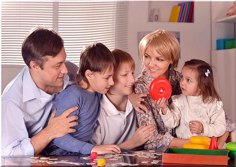 Family playing educational board games that encourage reading.