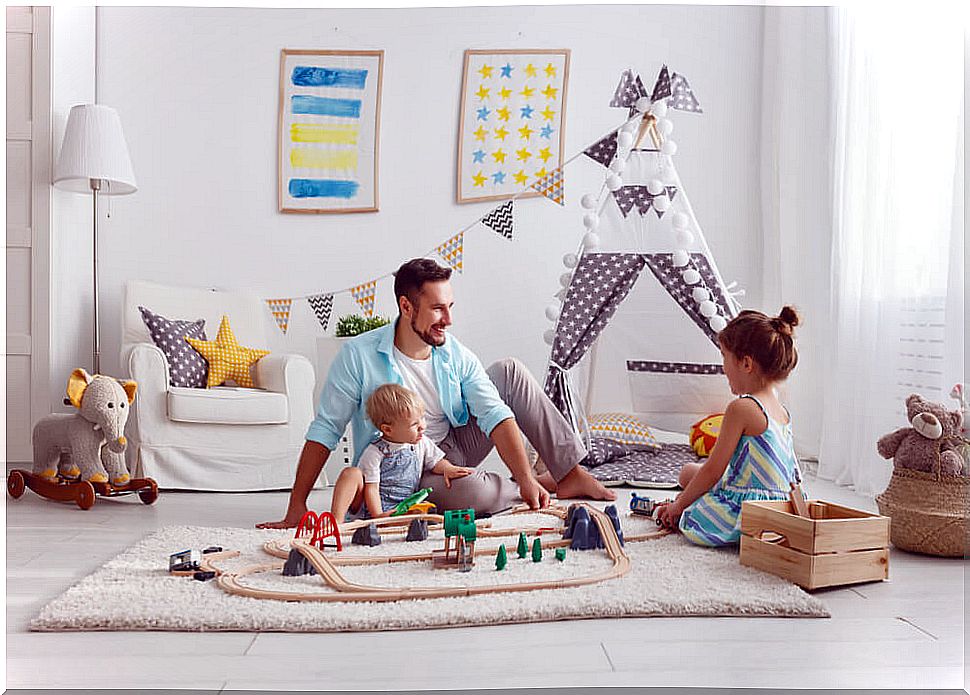 Father playing with his children in the living room at home.