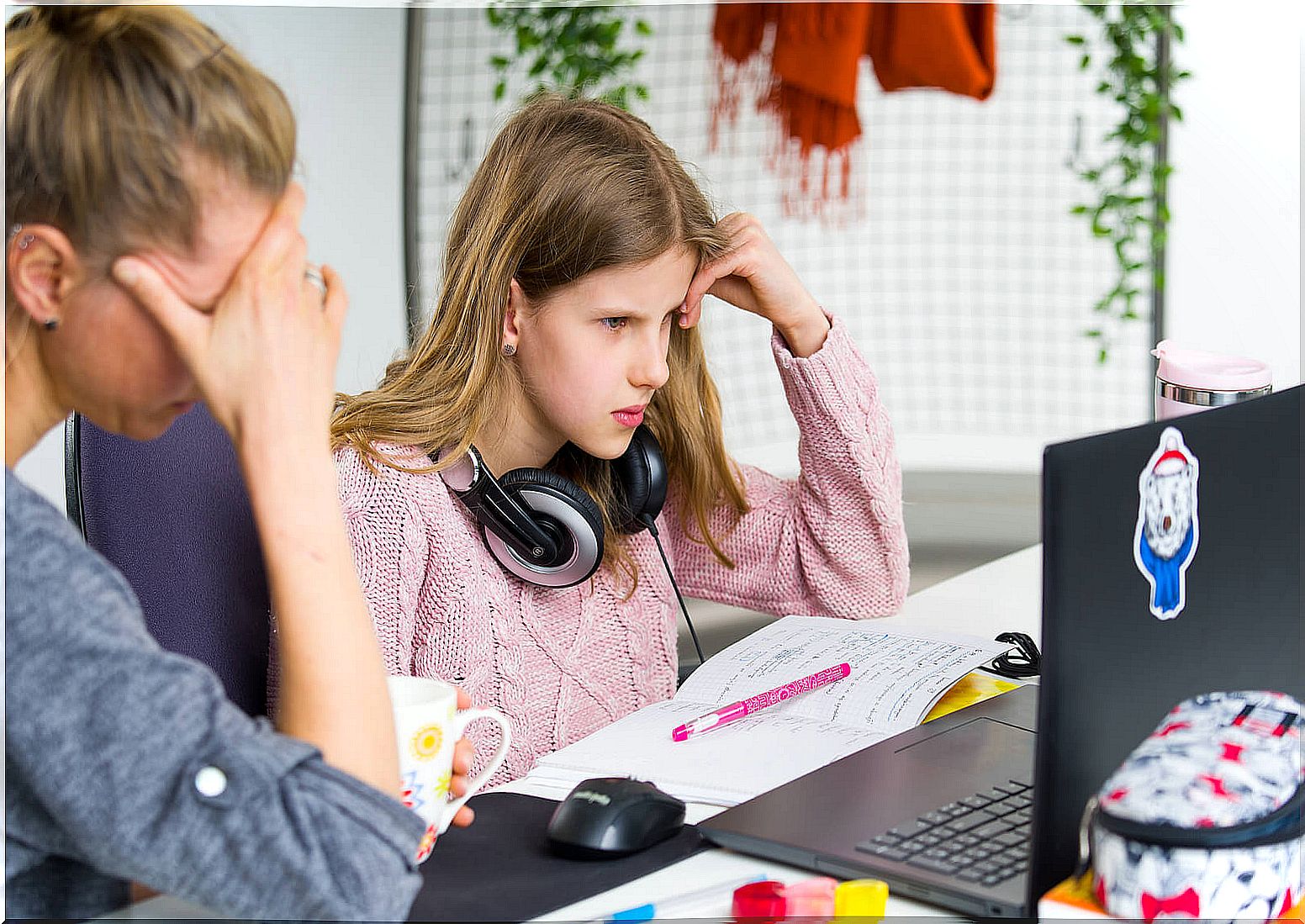 Teen girl with her mother doing homework.