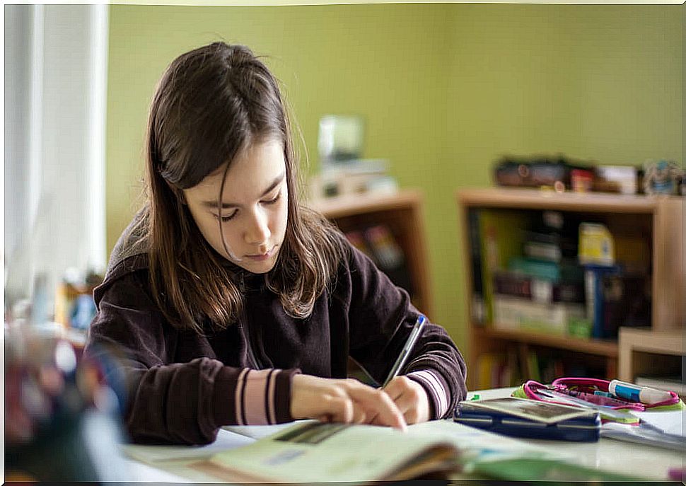 Little girl in her room studying without stress from homework.