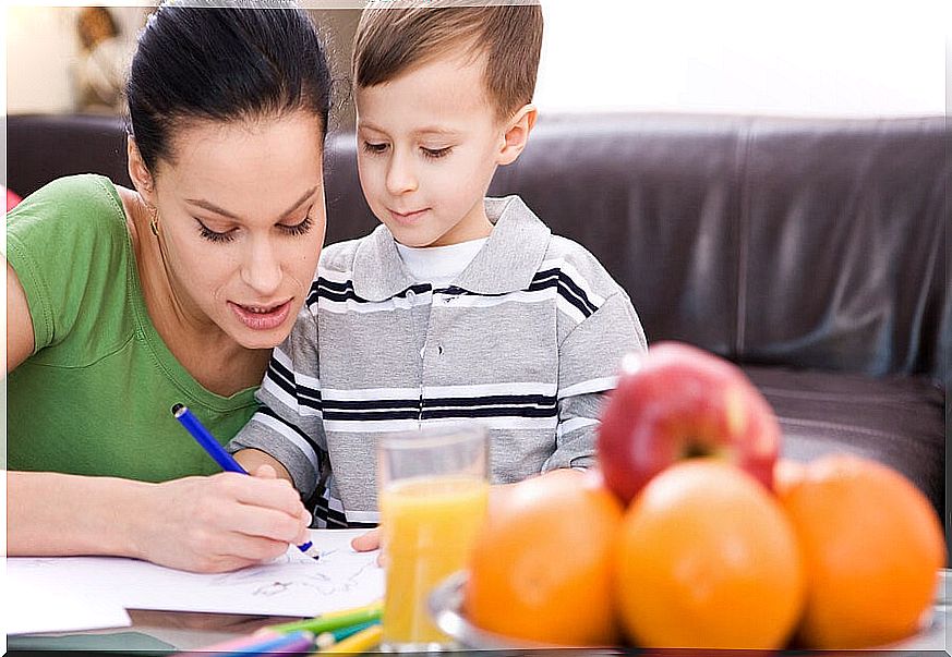 Mother and son doing homework in the living room.