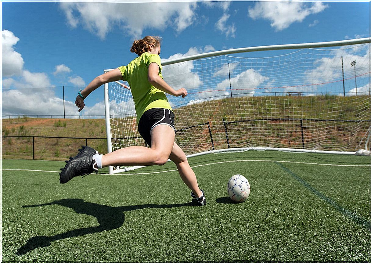 Teen girl playing soccer.