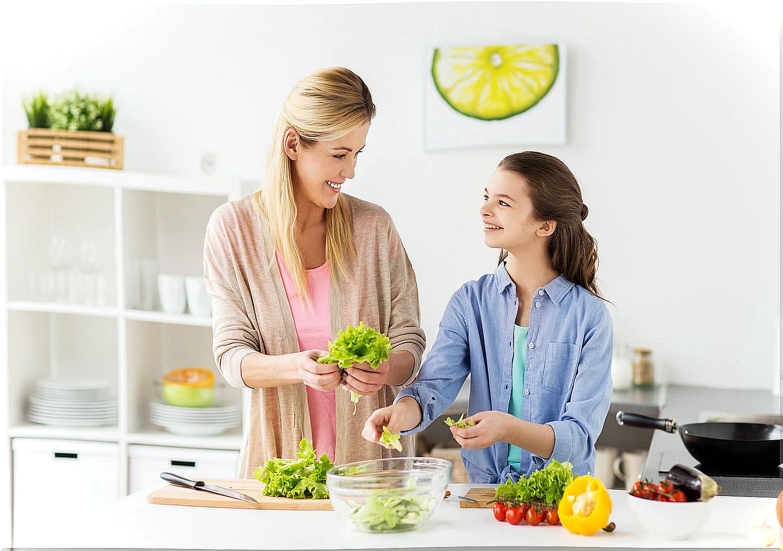 Mother and daughter cooking vegan food.