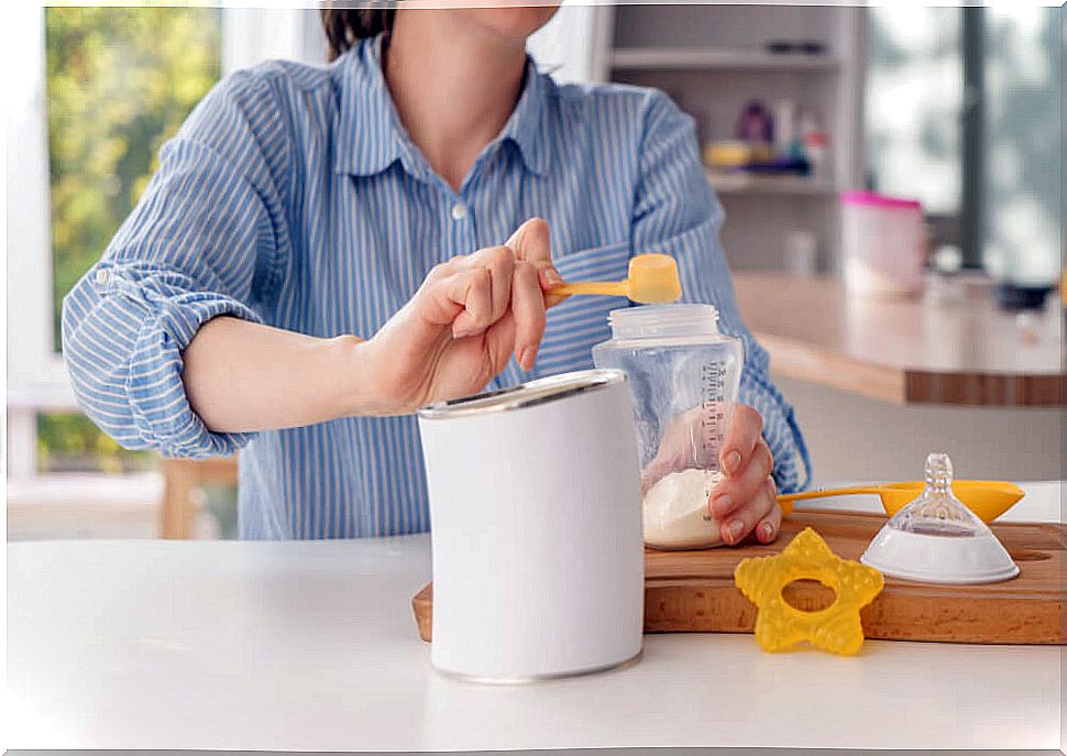 Mom preparing bottles of special milk and infant formulas for her baby.