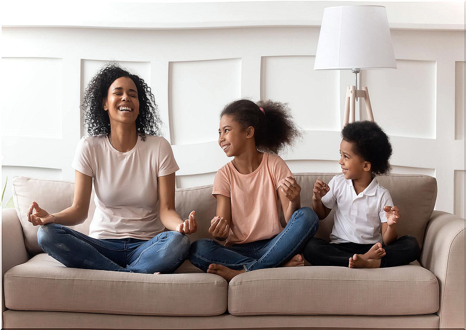 Mother and children doing yoga, one of the children's meditation exercises.