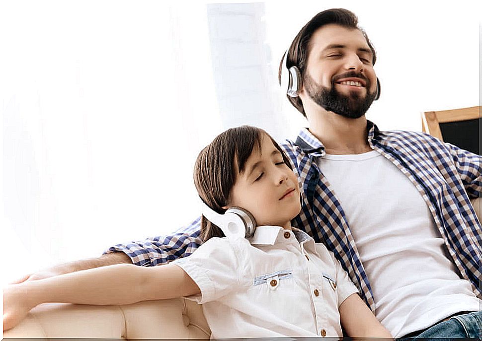 Father with his son in a music therapy session at home.