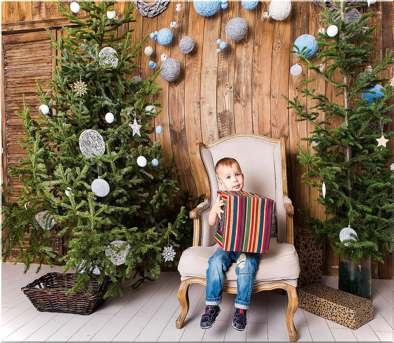 Child opening gift at Christmas.