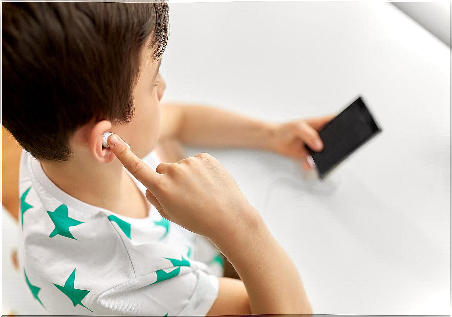 Child listening to a podcast at home.