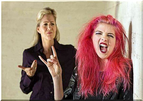 Teen girl with pink hair ignores her mother.