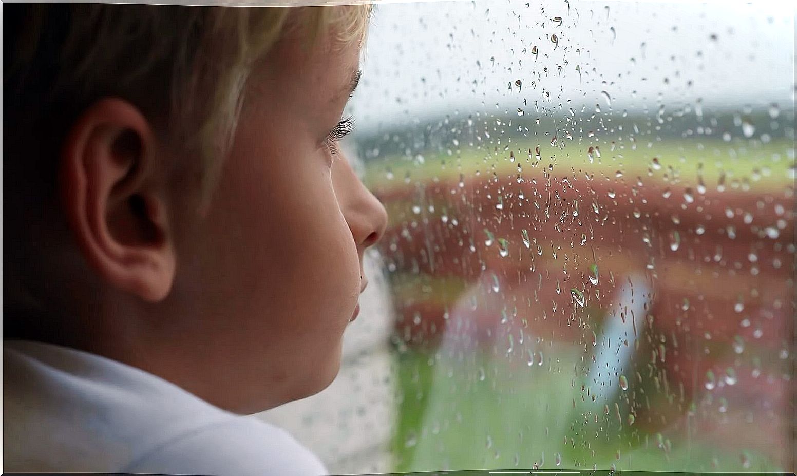 Boy looking out the window thinking about suicide.