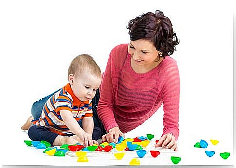 Mother and son playing with colored pieces