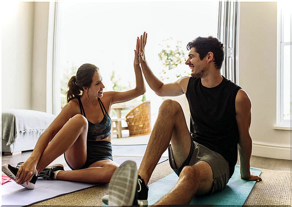 Couple exercising at home during quarantine.