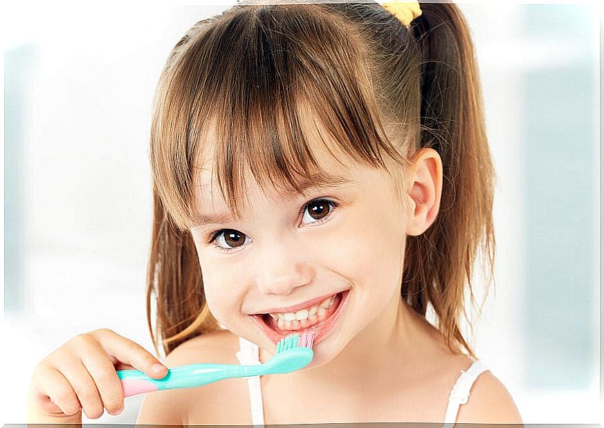 When should a child start brushing their teeth?