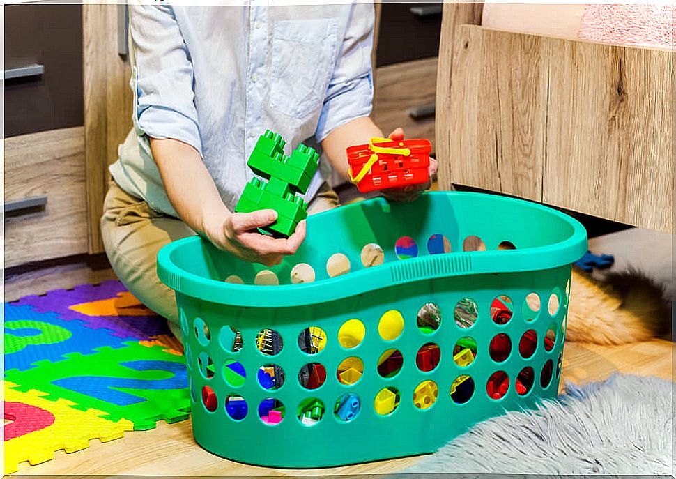 Children putting away their toys and cleaning the room.